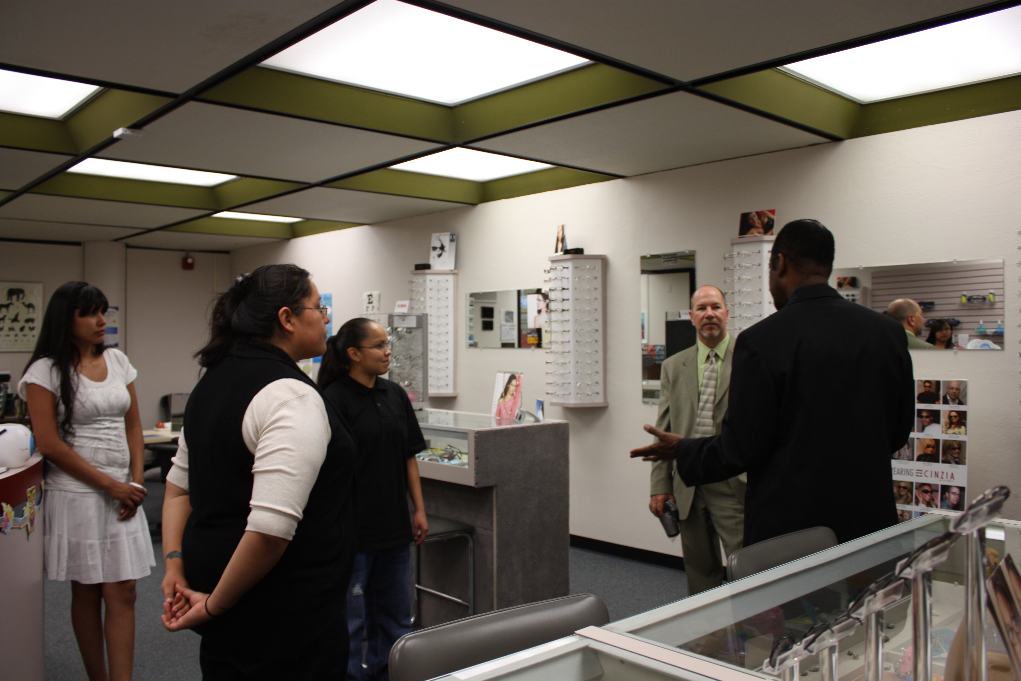 Sam Henderson, coordinator instructor, Vision Care Technology, shows Davis Vision's Tom Davis around the Vision Care Technology Unit, where many of the donated frames will be used for training purposes.